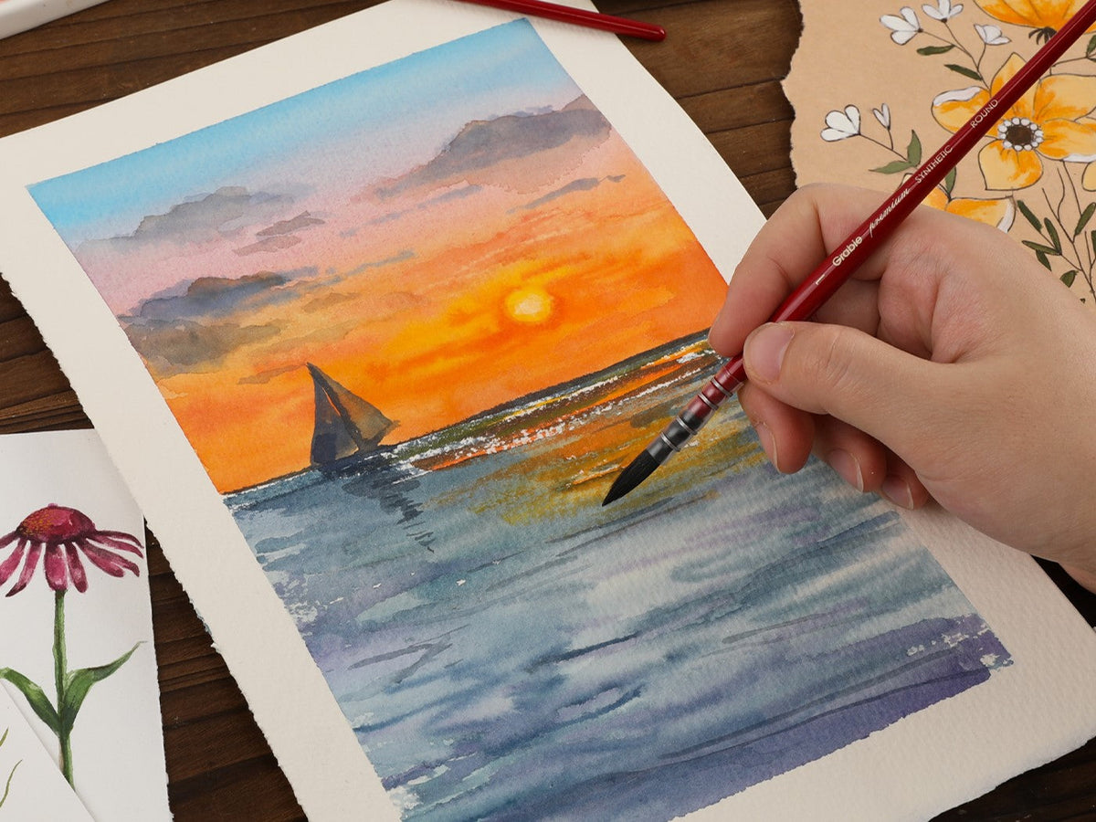 Hand painting watercolor sunset seascape with sailboat using round paintbrush and art supplies