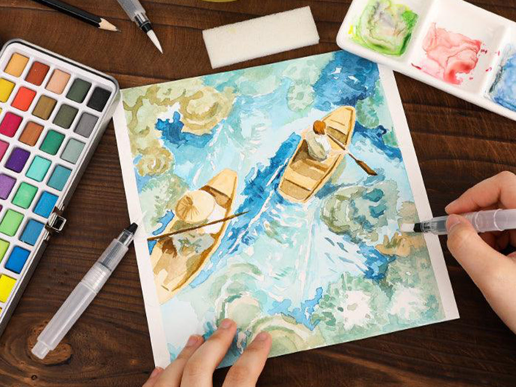 Hand painting a watercolor scene with boats using watercolor paint set and brush on table
