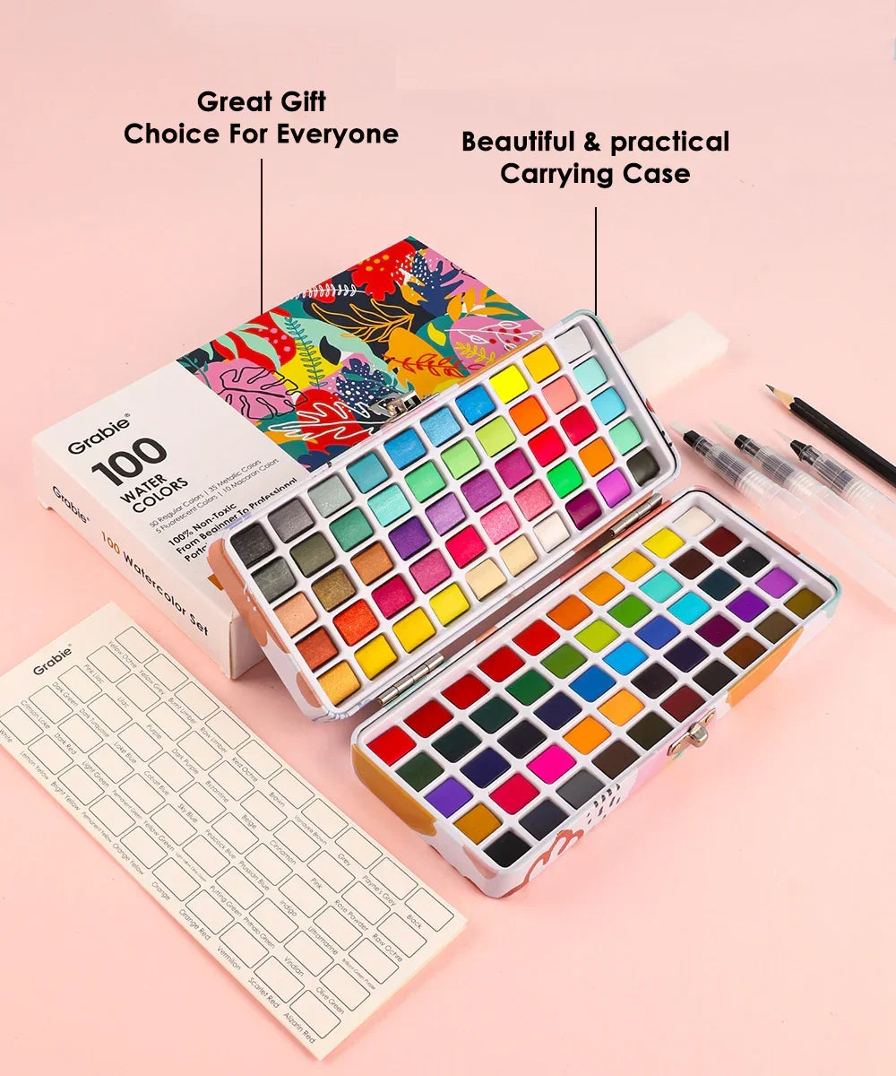 Watercolor Travel Set of 100 With Brush featuring vibrant colors, carrying case, water brushes, and color chart on a pink background