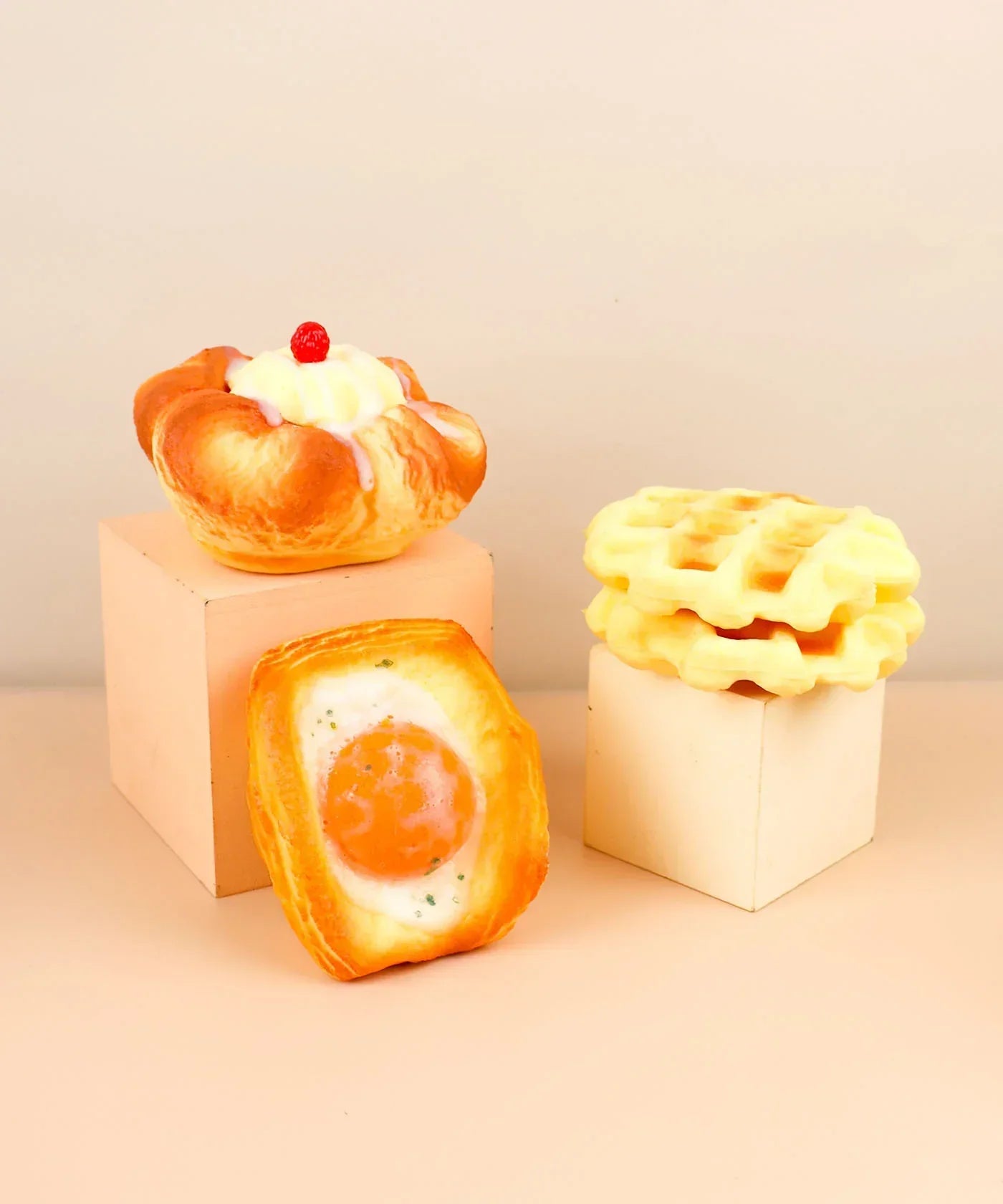 Feel-Good Stress Relief Foam Squishy - Fried Egg Bun with other foam food squishies displayed on blocks