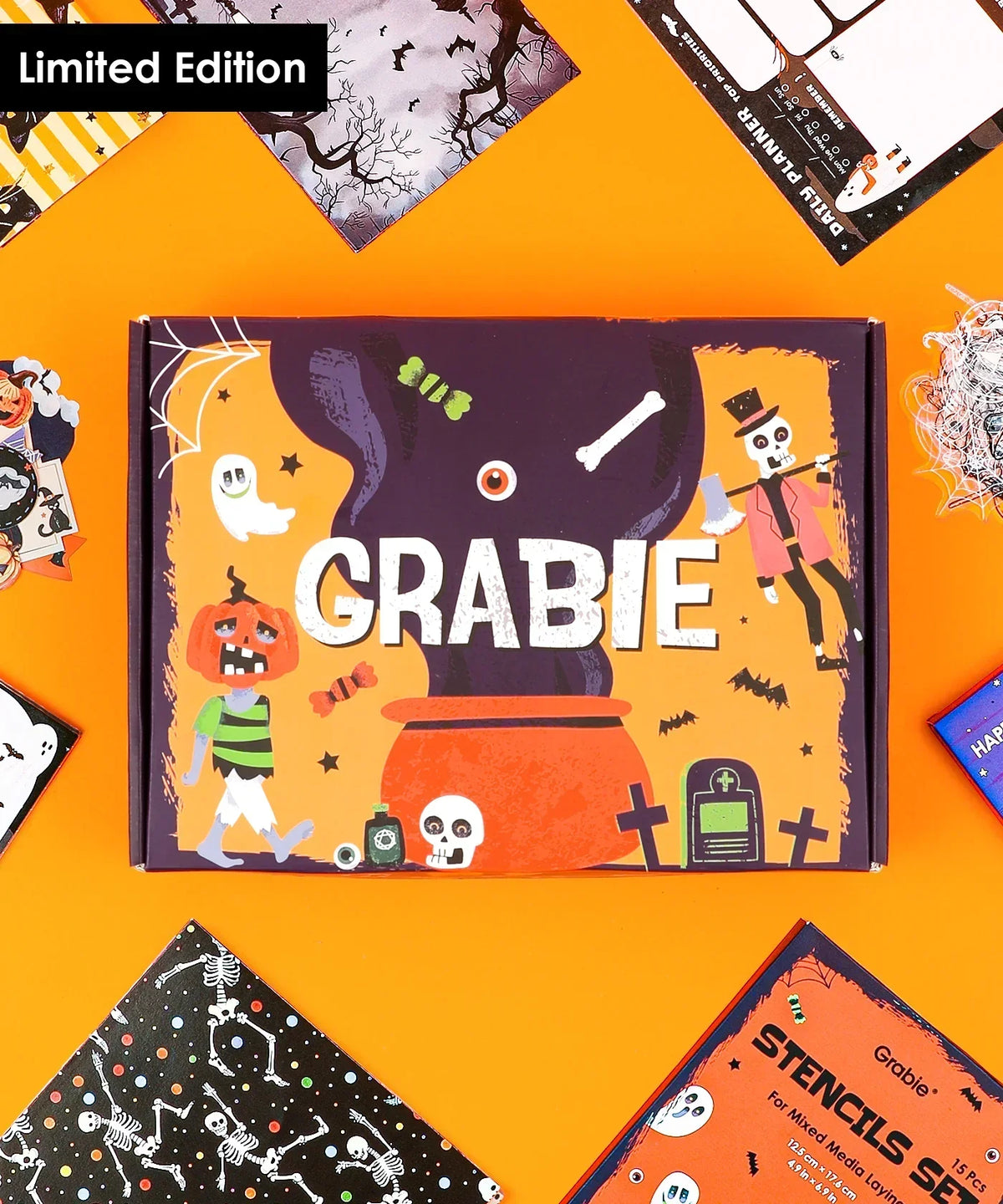 Halloween-Themed Grabie Scrapbook Club Box with spooky designs and art supplies laid out on an orange background