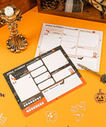 Daily planners with Halloween-Themed Grabie Scrapbook Club Box design featuring pumpkins, bats, ghosts, and space for notes and priorities.