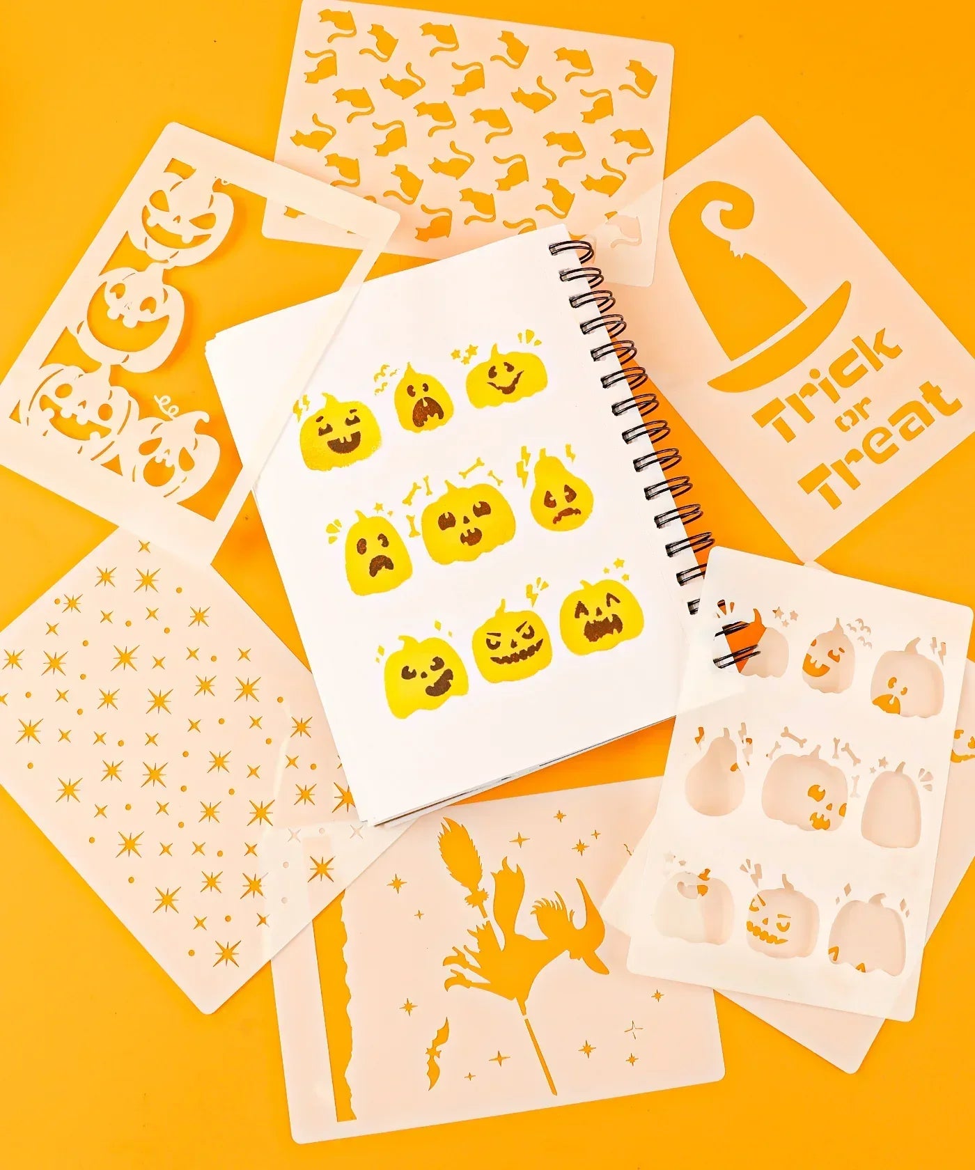 Halloween-Themed Grabie Scrapbook Club Box with pumpkin stencils and Halloween art supplies on orange background