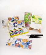 2026 Watercolor Calendar & Creative Tools Set with watercolor paints, brushes, and a desk calendar featuring artwork