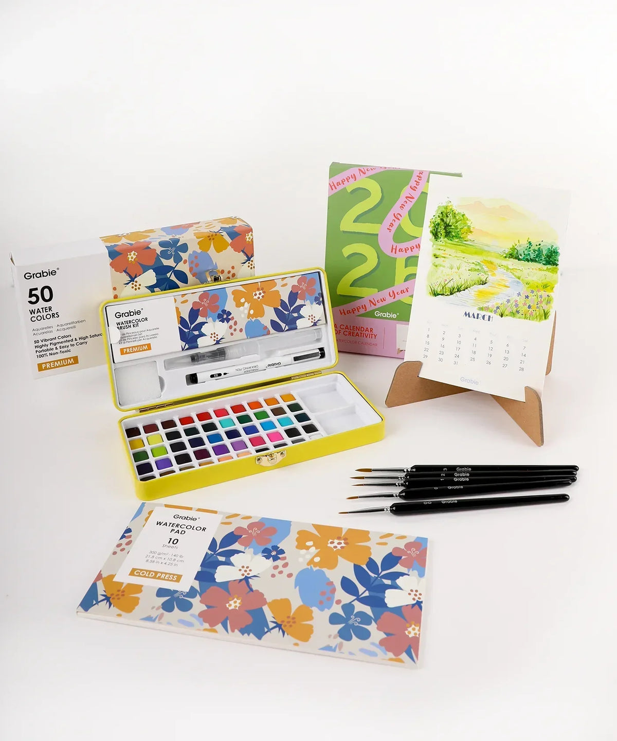 2026 Watercolor Calendar & Creative Tools Set with watercolor paints, brushes, and a desk calendar featuring artwork