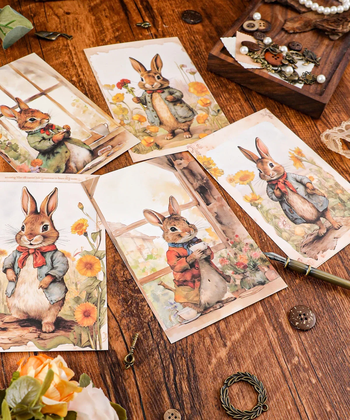 Grabie Exclusive 6 Pack Postcards With 6 Matching Envelopes featuring watercolor rabbits in vintage-style outfits on wooden table