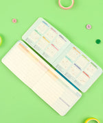Open 2-IN-1 2025 Monthly & Weekly Planner showing colorful monthly calendars and weekly schedule on green background
