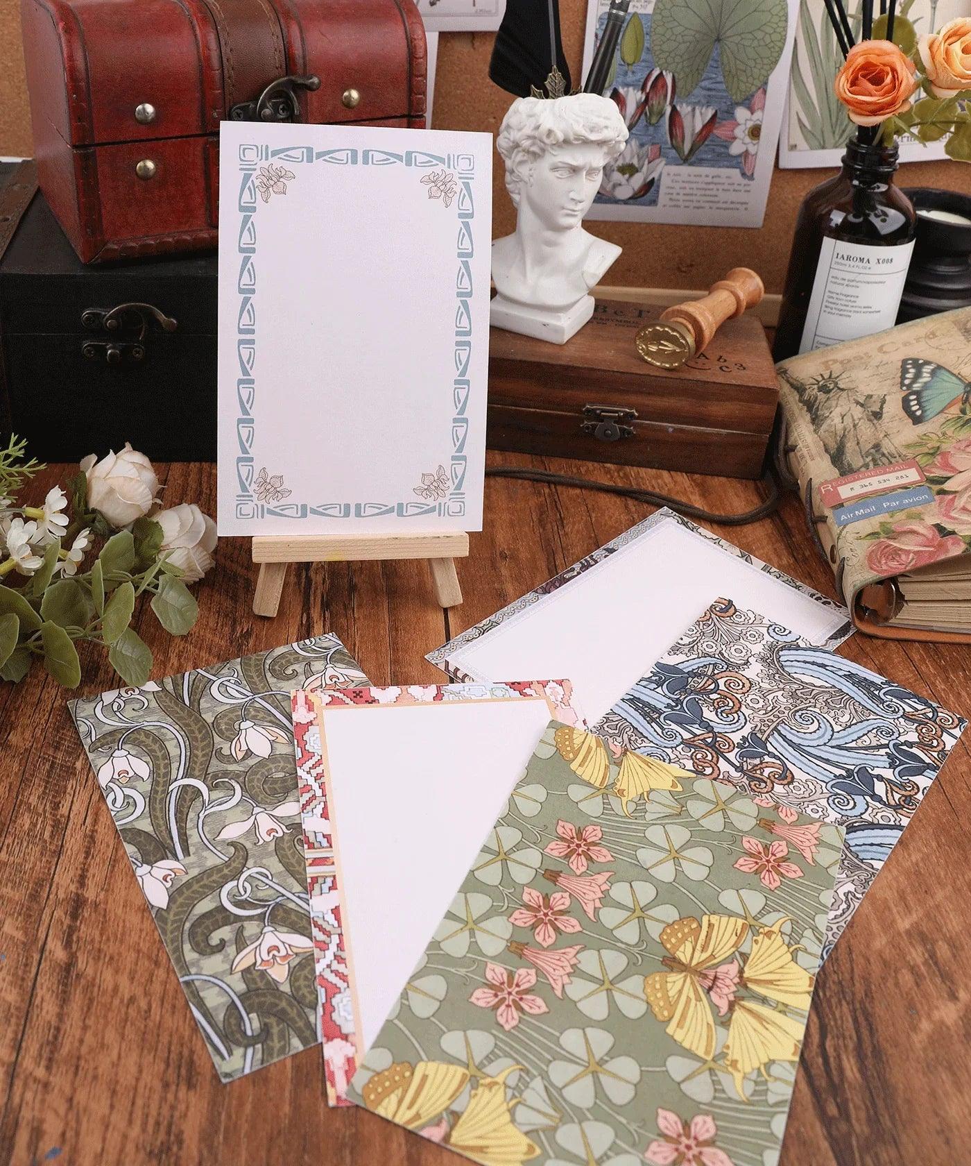 6 Pack Postcards With 6 Matching Envelopes featuring floral and patterned designs displayed on a wooden table with decor.
