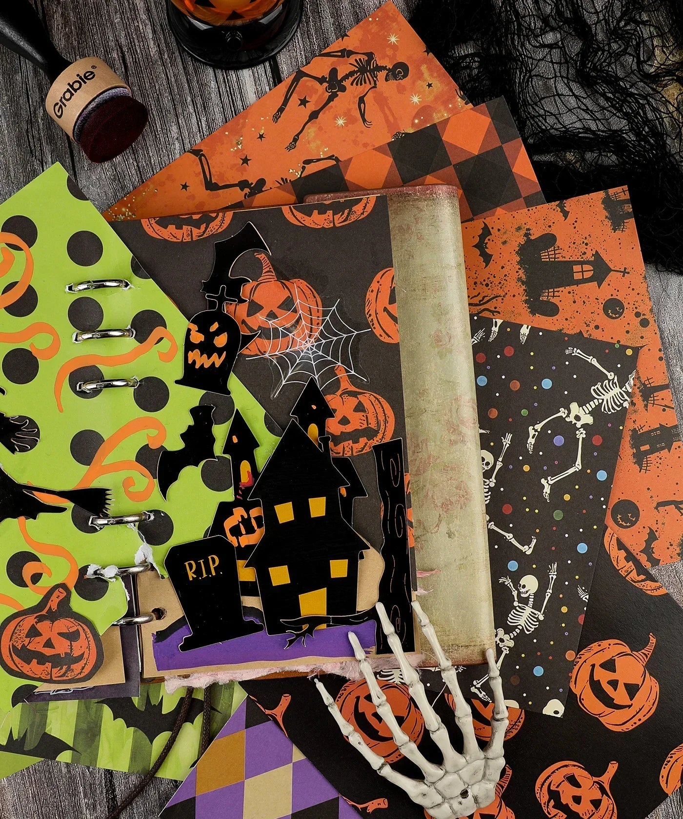 16 Sheets Grabie Exclusive Halloween Party Paper Set with spooky pumpkin, skeleton, and haunted house designs on decorative paper sheets