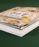 The Botanical Muse-Themed Grabie Scrapbook Club Box showing stacked pages of a floral collage book with art supplies theme