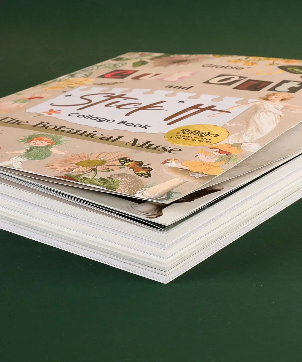 The Botanical Muse-Themed Grabie Scrapbook Club Box showing stacked pages of a floral collage book with art supplies theme