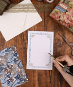 6 Pack Postcards With 6 Matching Envelopes showcasing ornate design and a hand holding a decorative pen on wooden table