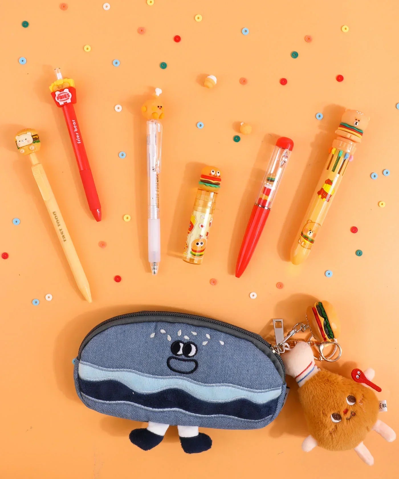 Colorful pens and pencil case with playful food-themed charms from Mouthwatering Foodie Stationery Set Of 9