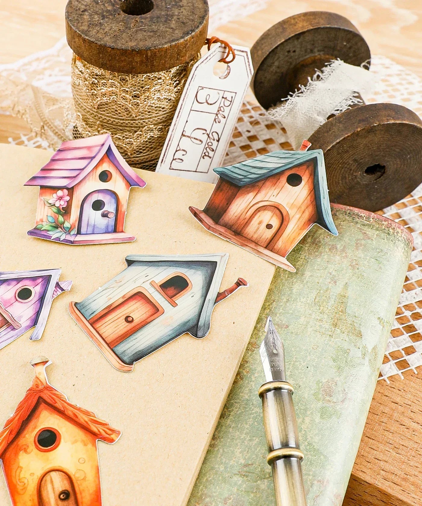 20 Pcs Grabie Exclusive Fairybird House Sticker Set with colorful birdhouse designs on a notebook and craft supplies.
