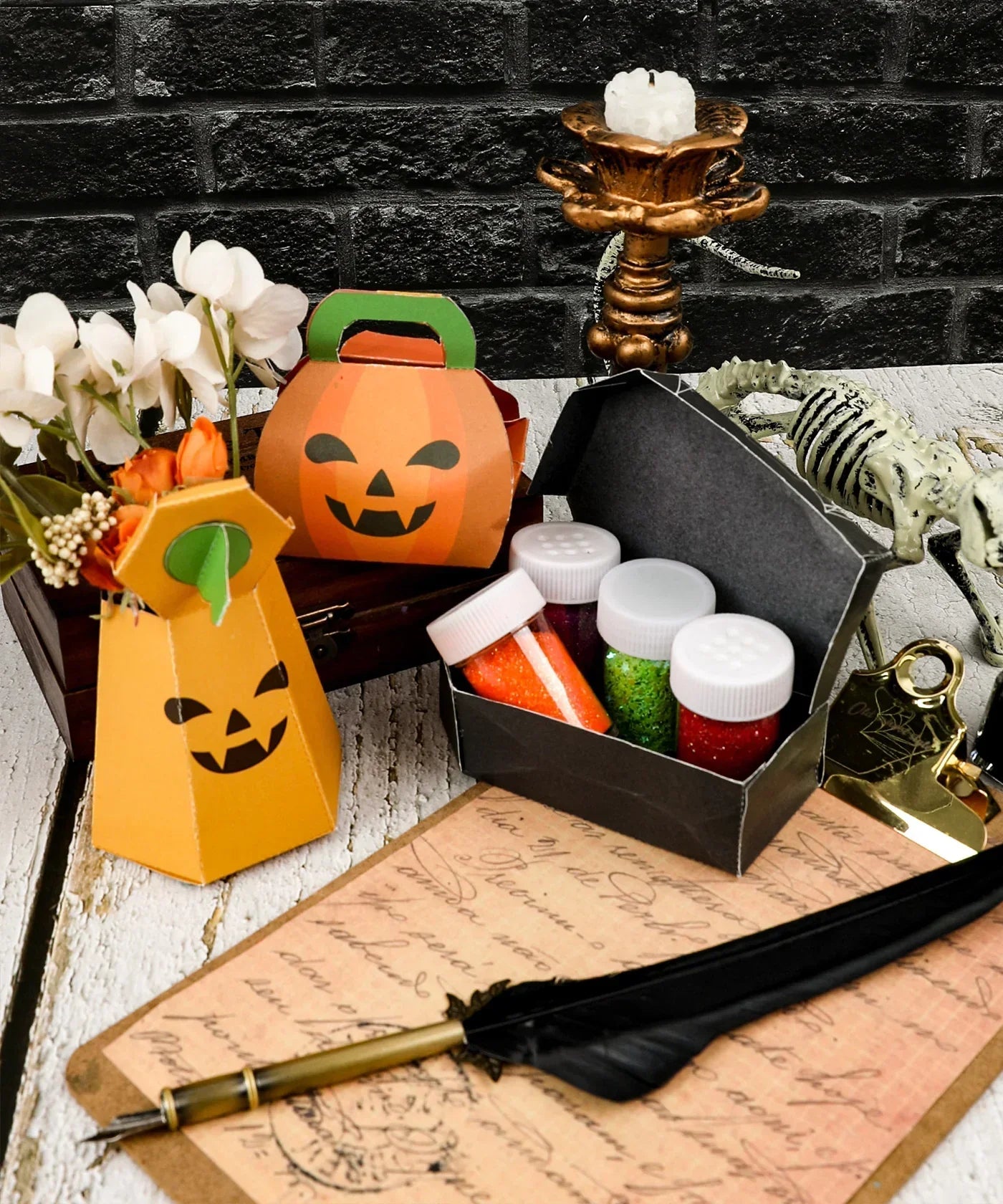 3 Sheets Grabie Exclusive Halloween DIY Kit with pumpkin containers, glitter jars, feather pen, and spooky decor on table