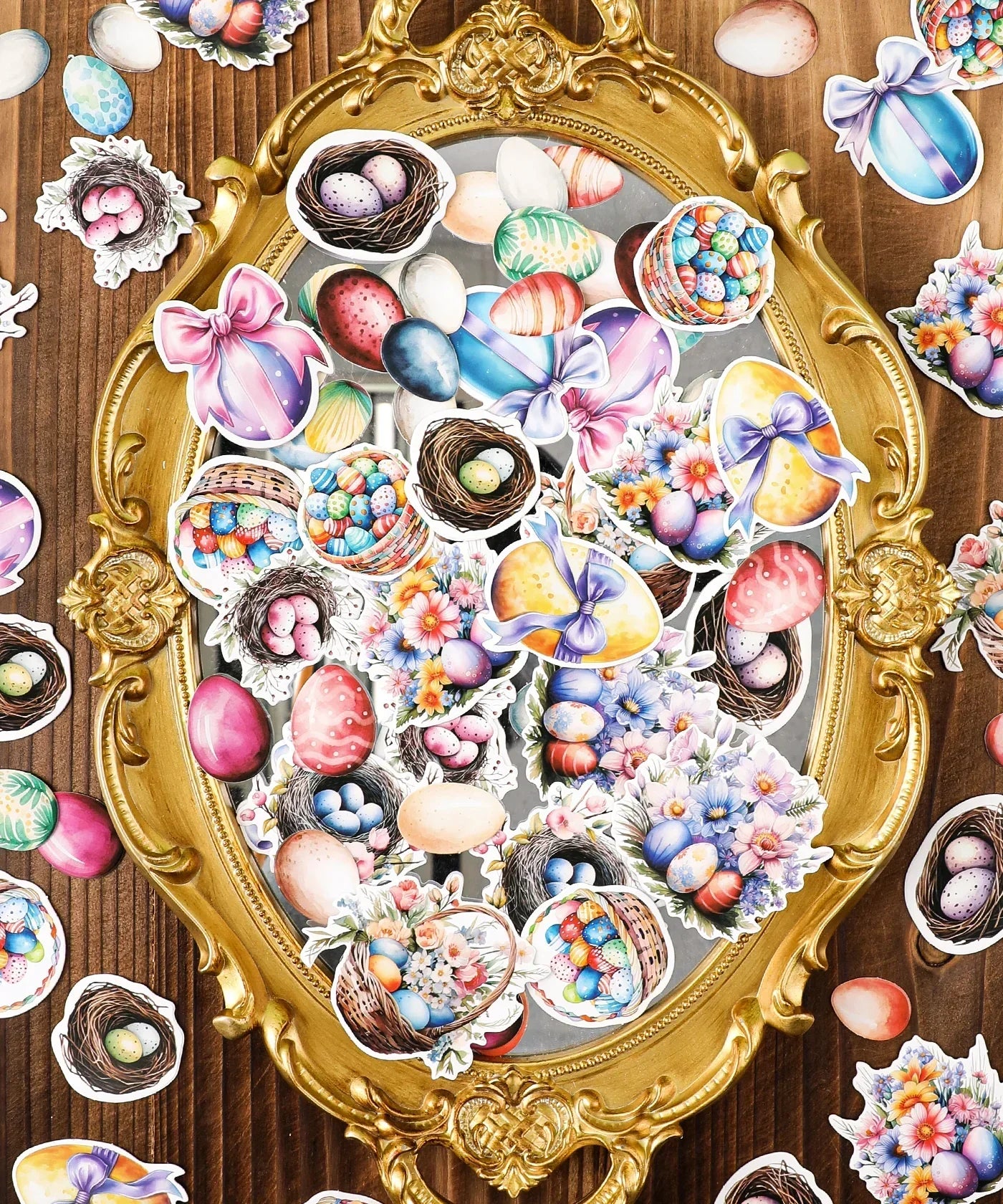 52 Pcs Grabie Exclusive Hoppy Easter Sticker Set with colorful eggs, baskets, and floral designs on an ornate gold mirror