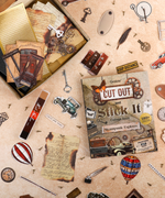Steampunk Explorer-Themed Grabie Scrapbook Club Box with vintage keys, hot air balloons, and collage art supplies scattered on table