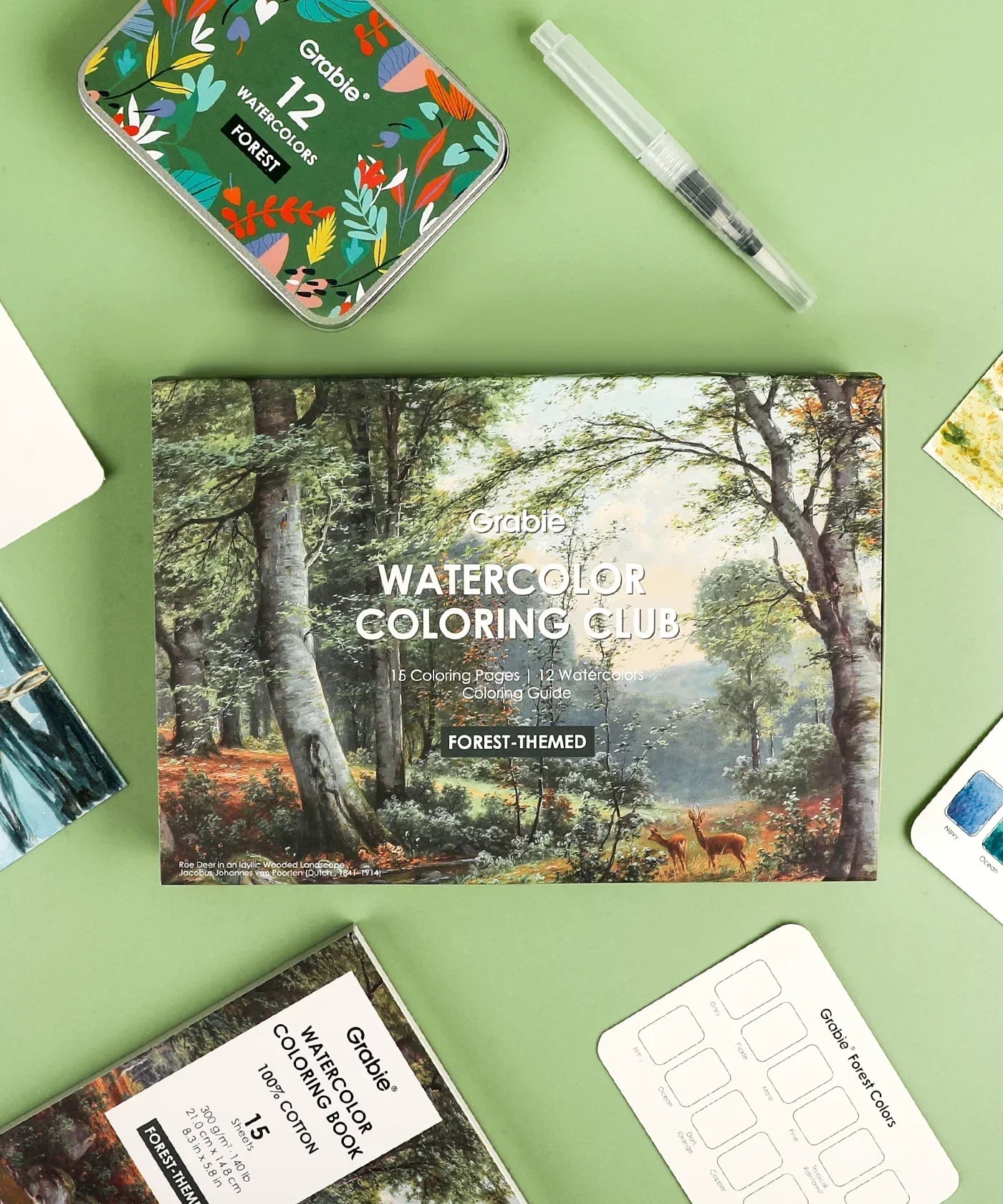 Forest-Themed Watercolor Coloring Club Box with art supplies including watercolor set, brush pen, and color guide on green background