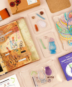 Happy Halloween Clear Photopolymer Stamps arranged with scrapbook and art supplies for creative journaling projects.
