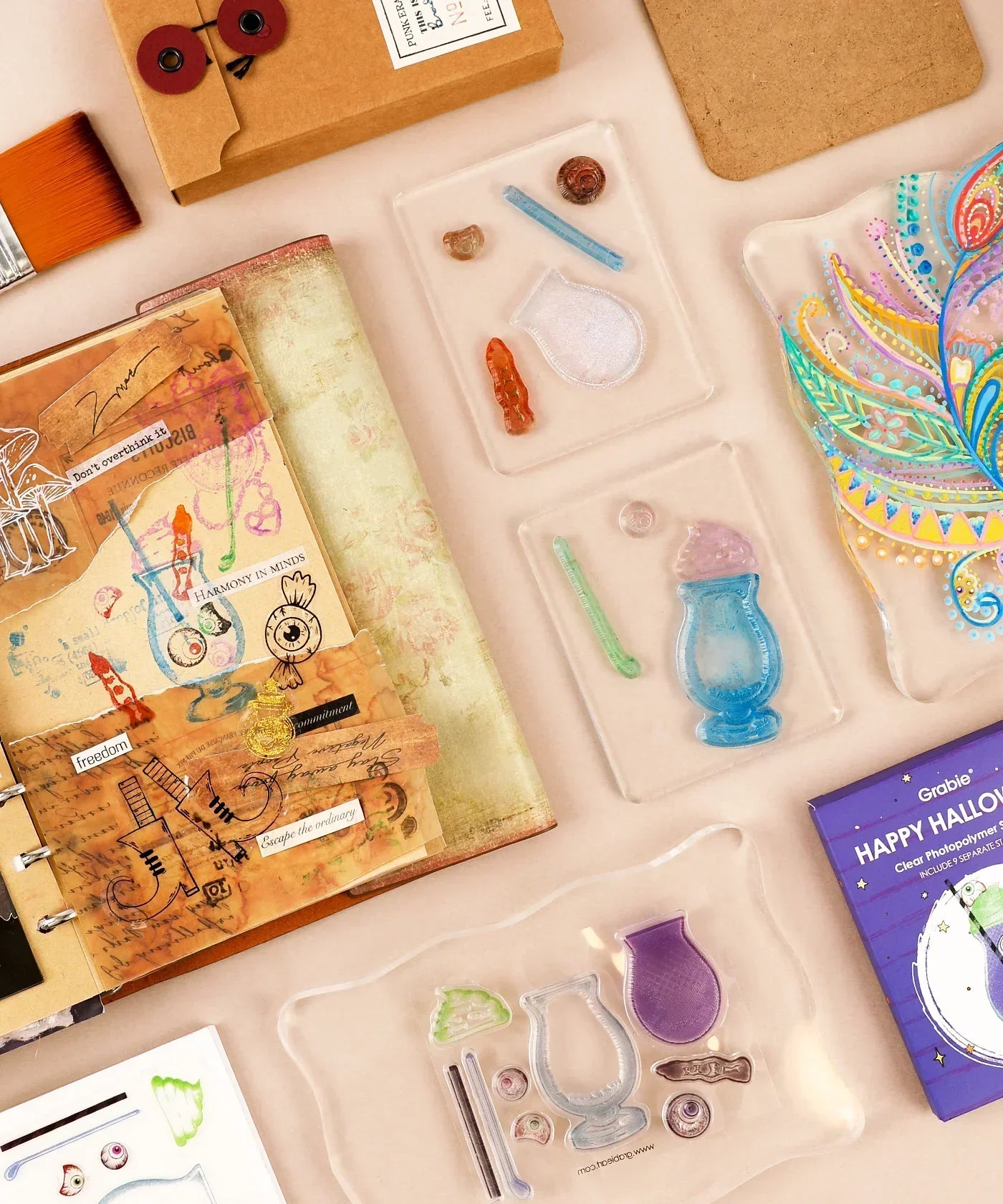 Happy Halloween Clear Photopolymer Stamps arranged with scrapbook and art supplies for creative journaling projects.