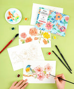 15 Sheets 140LB Floral-Themed Watercolor Coloring Book with floral art, paintbrushes, watercolor palette, and hand painting bird design