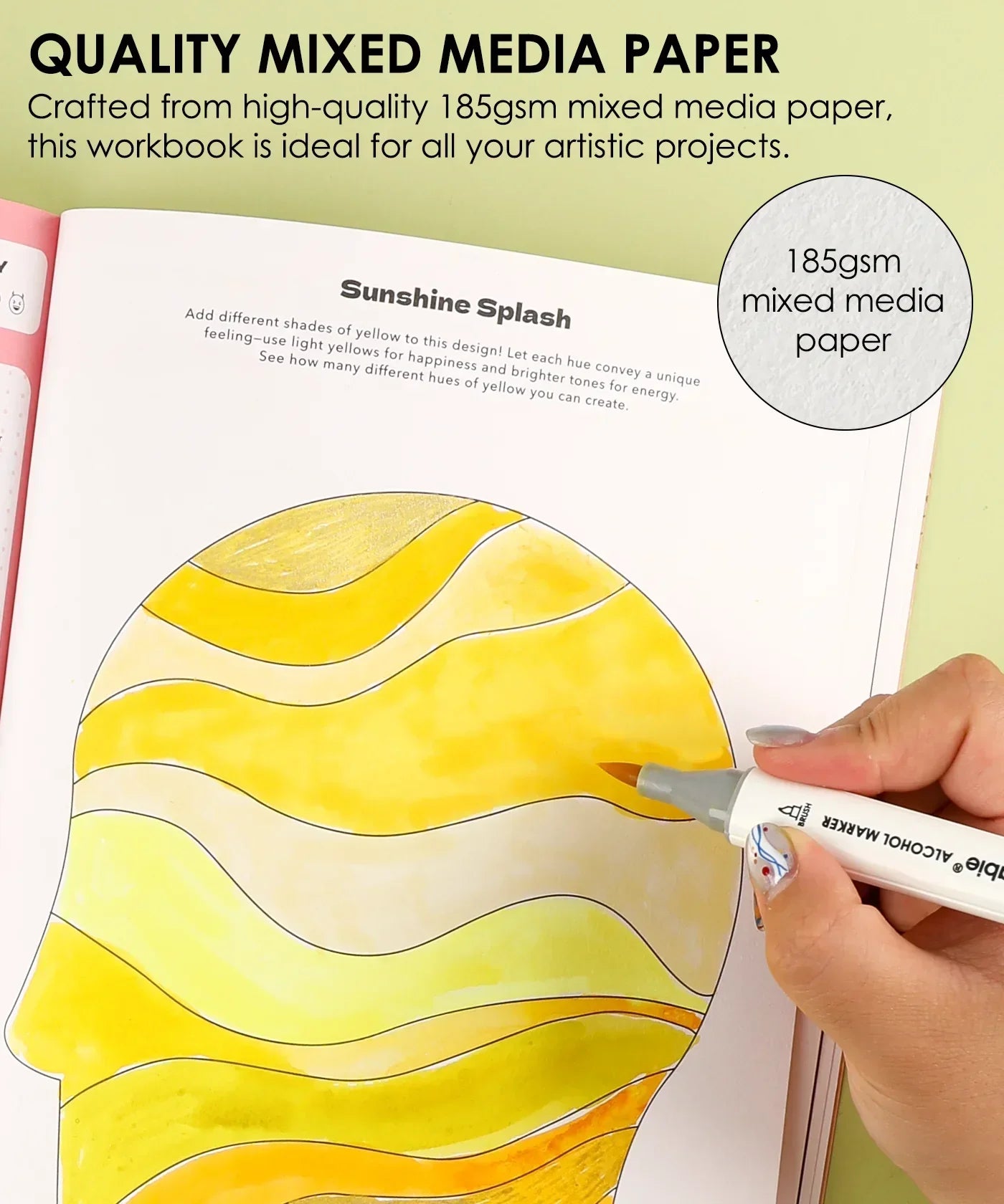 Hand coloring a yellow abstract design in Grabie x AATA Rock Your Inner Strength 4-Week Workbook on mixed media paper