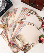 Grabie Exclusive Desktop Notepad Jotter with vintage floral and animal-themed writing paper spread on a table.