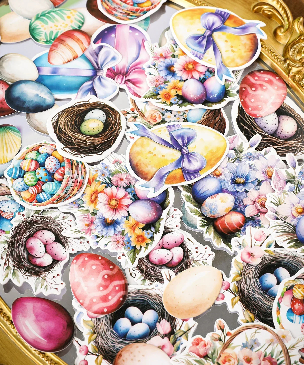 Assorted colorful Easter eggs, nests, flowers, and bows from the 52 Pcs Grabie Exclusive Hoppy Easter Sticker Set