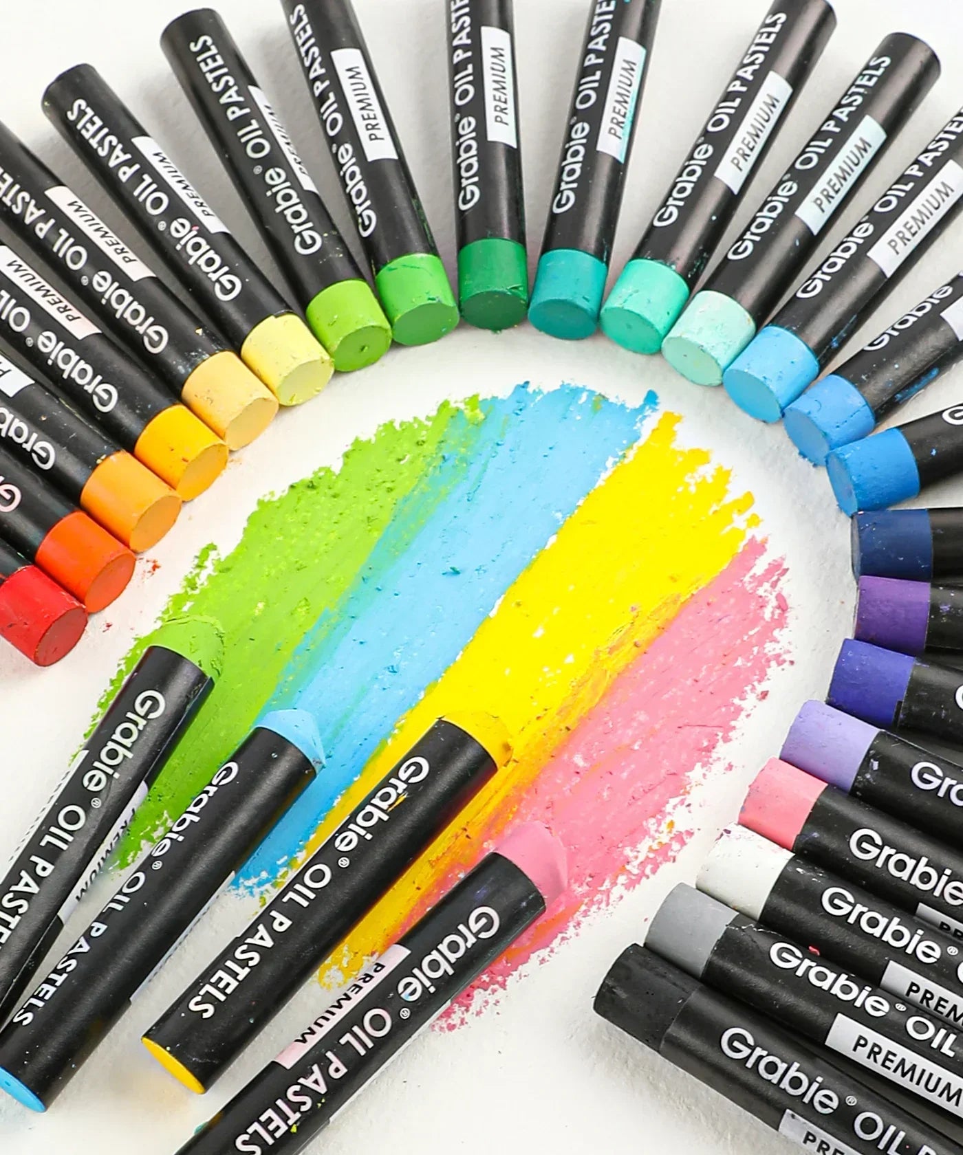 18 Colors Premium Oil Pastel Set arranged in a circle with vibrant swatches of green, blue, yellow, and pink tones displayed