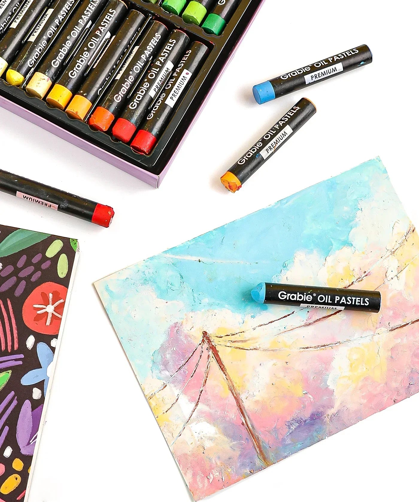 18 Colors Premium Oil Pastel Set with vibrant crayons and a colorful pastel artwork on textured paper.
