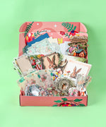 Easter-Themed Grabie Scrapbook Club Box with vintage bunny prints, floral papers, wreath cutouts, and layered craft supplies