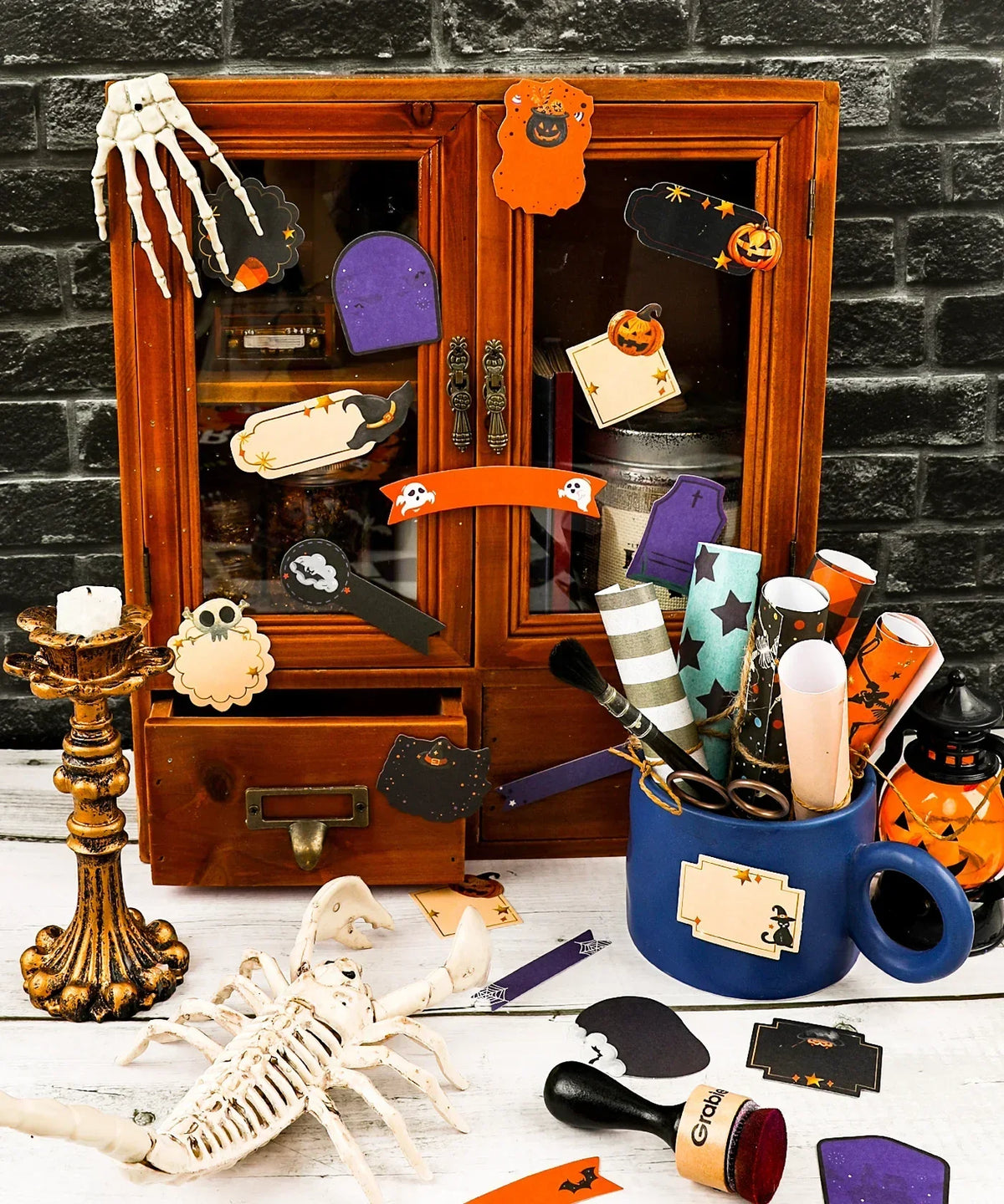 Decorative Halloween stickers on wood cabinet with spooky art supplies in cozy craft setting featuring 22 Pcs Grabie Exclusive Happy Haunting Sticker Set