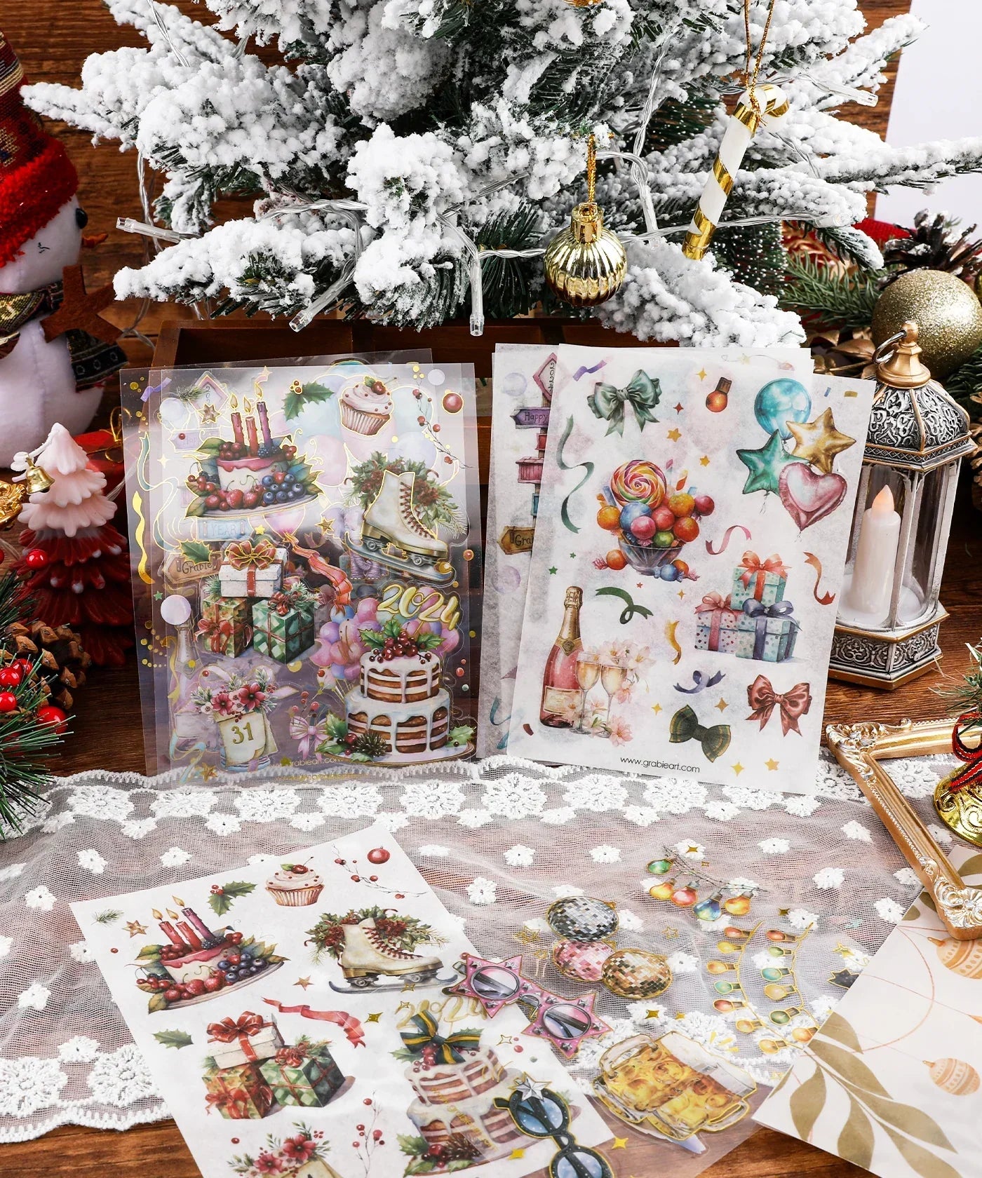 8 Sheets Grabie Exclusive New Year Sticker Set with festive designs for scrapbook and art supplies under a snowy Christmas tree