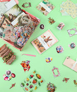 Easter-Themed Grabie Scrapbook Club Box featuring scrapbook paper, decorative stickers, washi tape, and crafting twine on green background
