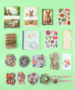 Easter-Themed Grabie Scrapbook Club Box with decorative papers, stickers, ribbons, and crafting supplies for scrapbooking.