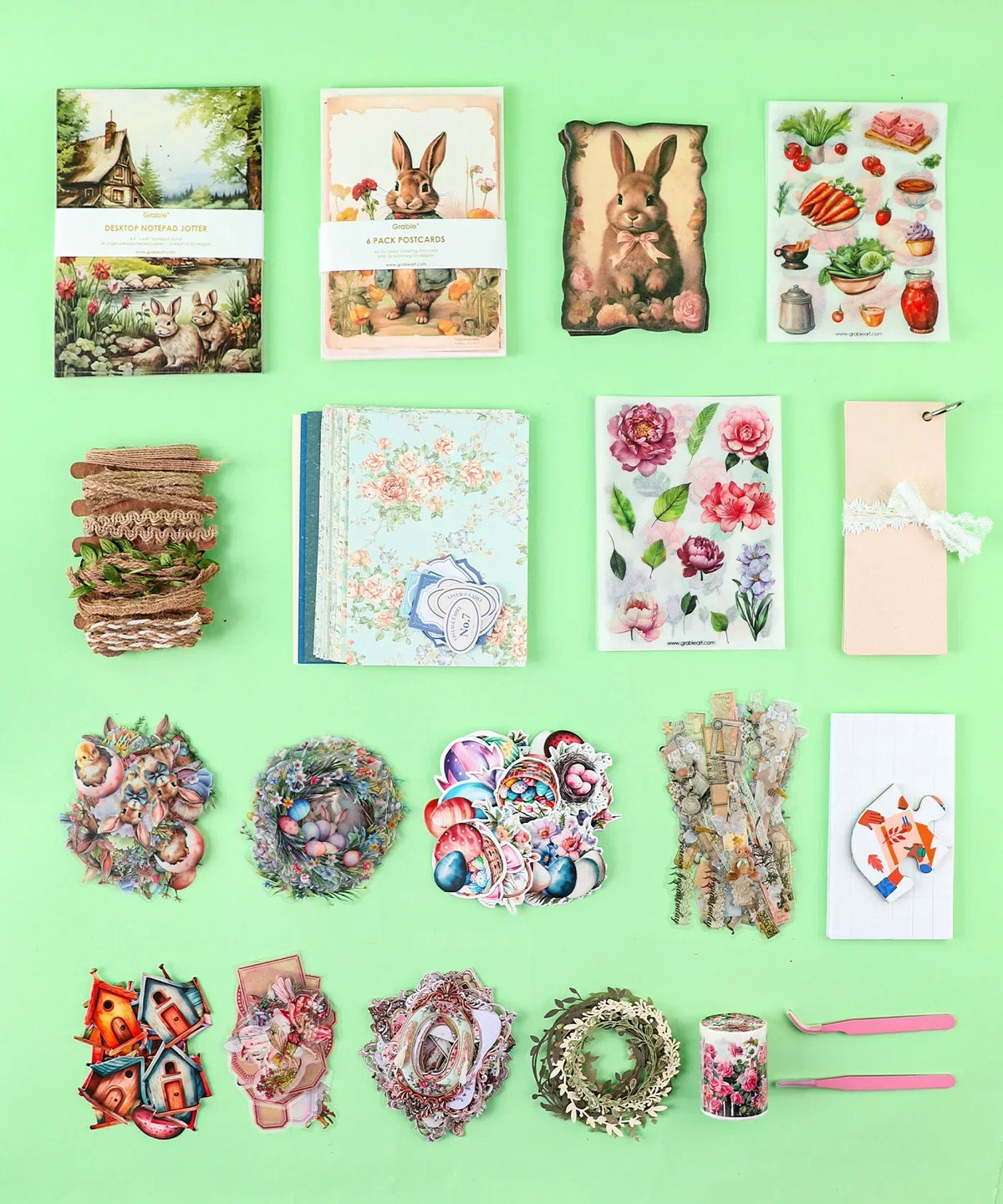 Easter-Themed Grabie Scrapbook Club Box with decorative papers, stickers, ribbons, and crafting supplies for scrapbooking.