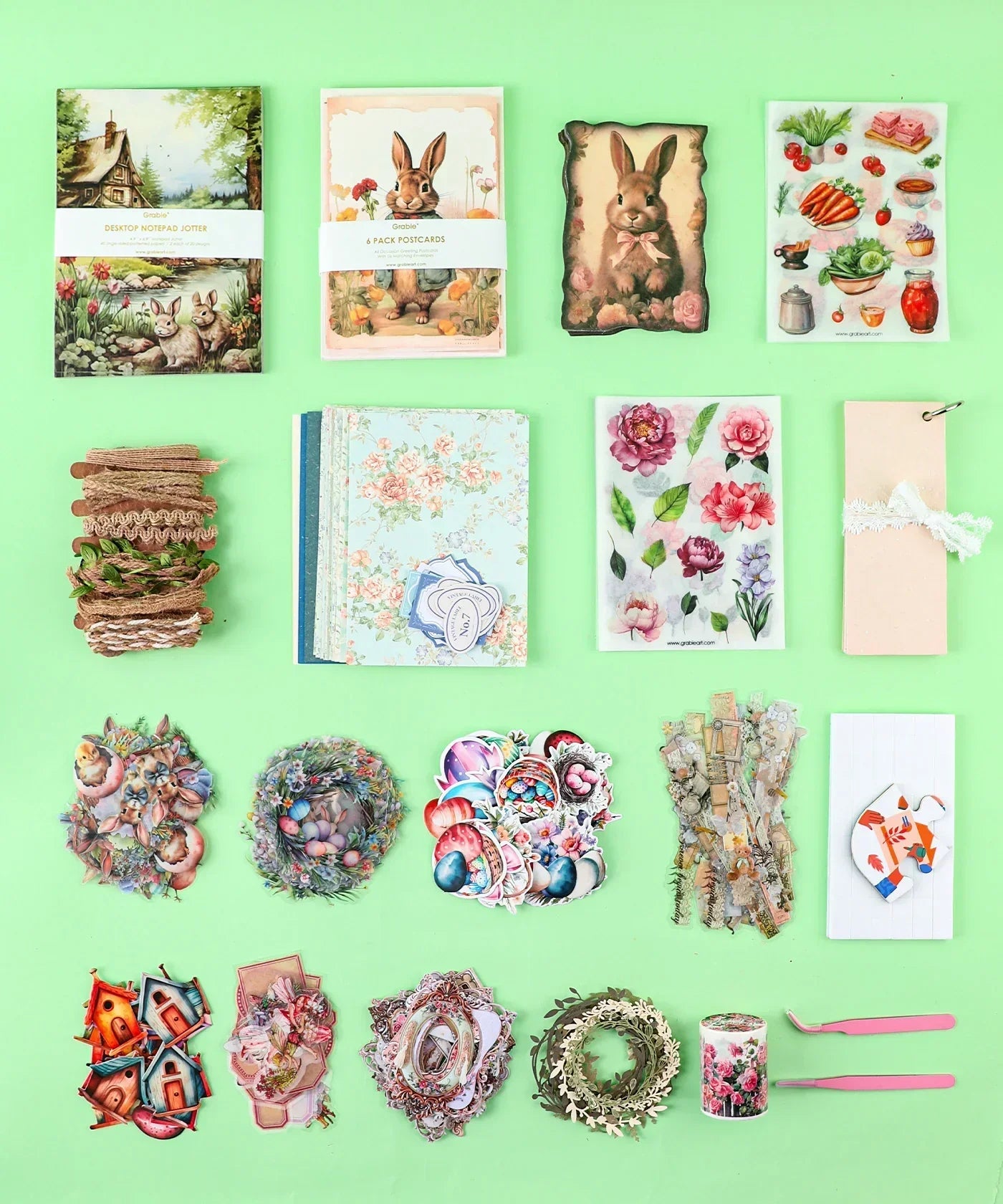 Easter-Themed Grabie Scrapbook Club Box with decorative papers, stickers, ribbons, and crafting supplies for scrapbooking.