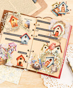 Open scrapbook with colorful birdhouse stickers and decorative elements from the 20 Pcs Grabie Exclusive Fairybird House Sticker Set