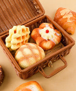 Feel-Good Stress Relief Foam Squishy - Waffle Sandwich displayed in an open wicker basket with dessert-shaped foam squishies inside.