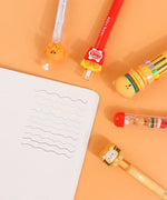 Mouthwatering Foodie Stationery Set Of 9 with colorful pens featuring playful food-themed designs and wavy ink lines on paper