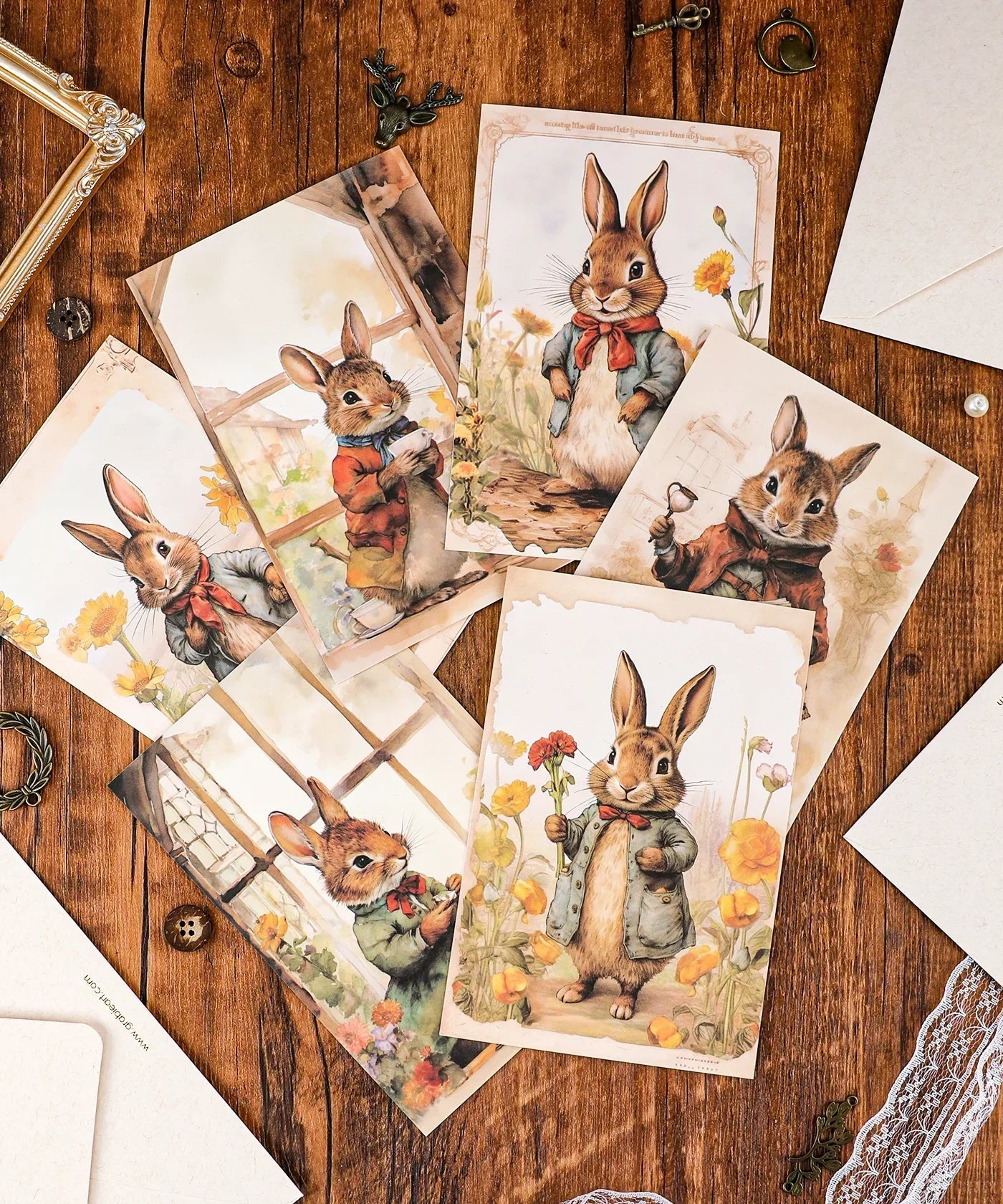 Grabie Exclusive 6 Pack Postcards With 6 Matching Envelopes featuring watercolor rabbits in vintage attire on wood surface.