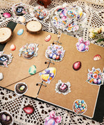 52 Pcs Grabie Exclusive Hoppy Easter Sticker Set featuring colorful Easter egg and floral designs on scrapbook pages