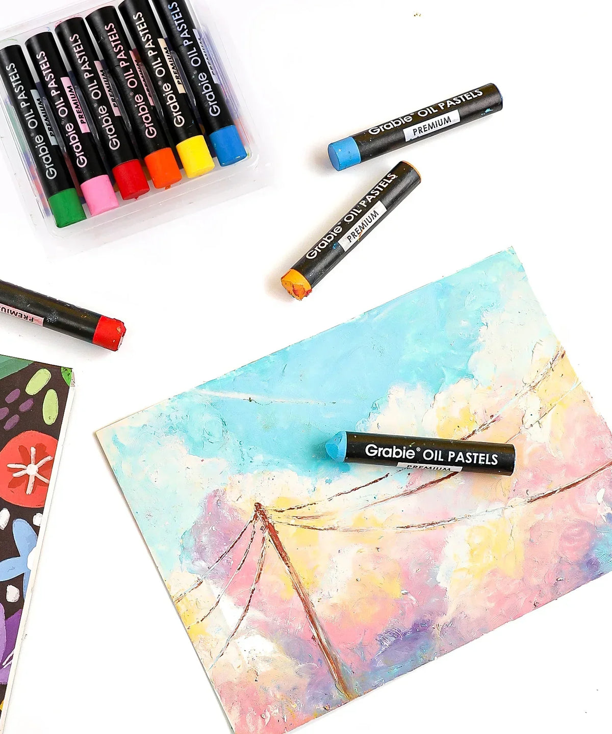 Premium Oil Pastel Set Of 6 vibrant colors with sample artwork showing creative pastel usage on paper.