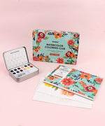 Floral-Themed Watercolor Coloring Club Box with floral design, watercolor palette, and coloring pages on pink background