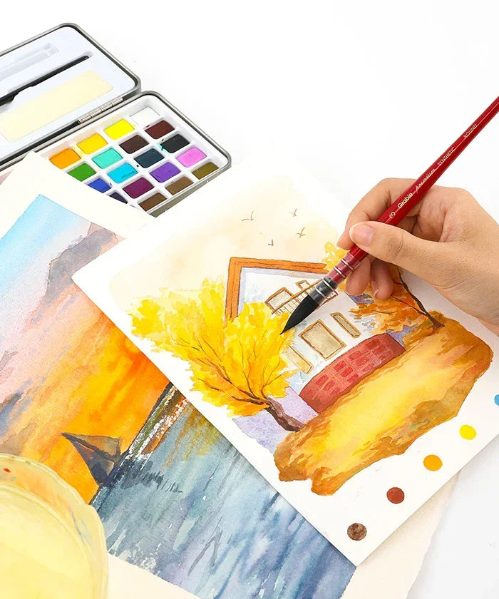 Hand painting a watercolor autumn scene using Watercolor Paint Brush Favorites Bundle with colorful palette nearby