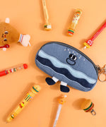 Mouthwatering Foodie Stationery Set Of 9 featuring playful food-themed pens and a cute whale pouch on orange background