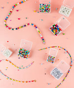 Colorful beads and small containers organized with the Grabie Bead Box for creative art supplies projects