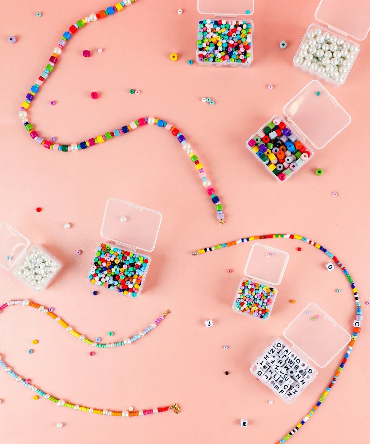 Colorful beads and small containers organized with the Grabie Bead Box for creative art supplies projects