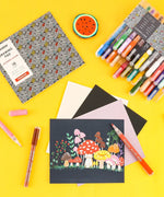Extra Fine Tip Acrylic Paint Marker Set of 28 displayed with illustrated mushroom artwork, pens, and drawing pad on yellow background
