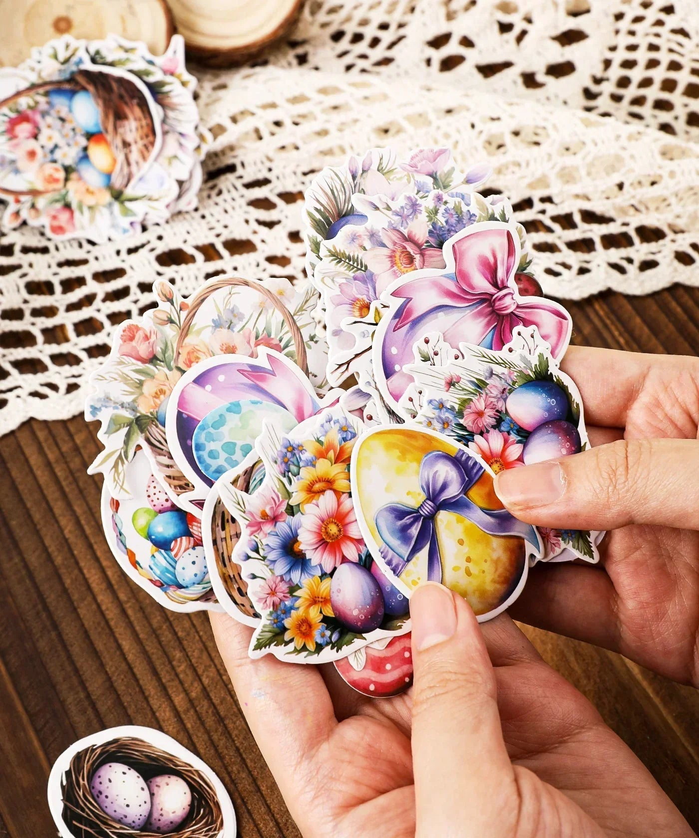 Hand holding colorful Easter egg and floral stickers from the 52 Pcs Grabie Exclusive Hoppy Easter Sticker Set